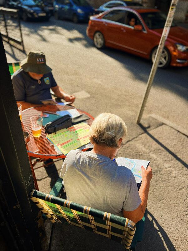 Travelers enjoying craft beer at SMA sidewalk terrace Tbilisi