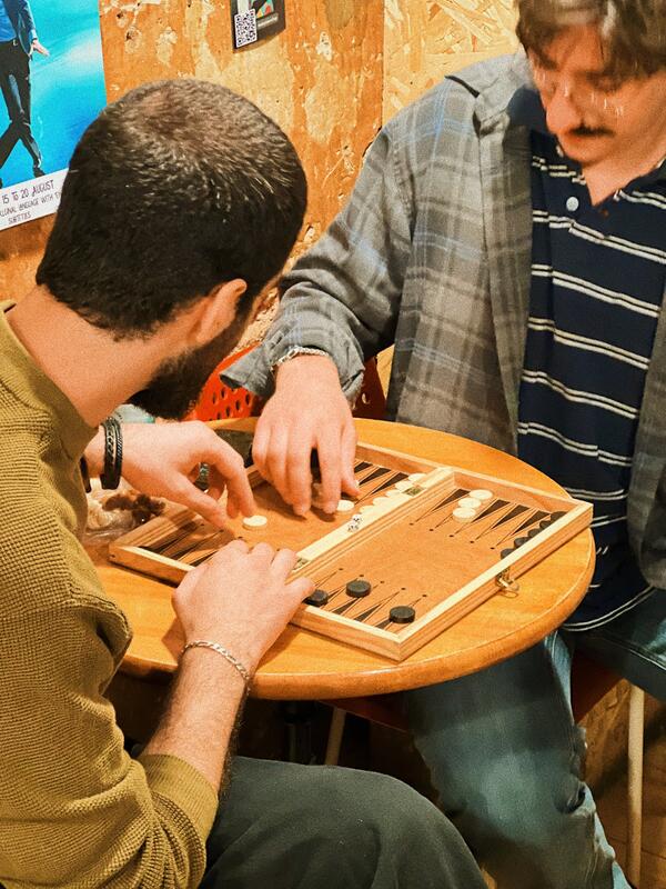 Friends playing backgammon at SMA craft beer bar