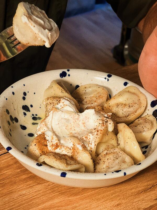 Homemade pelmeni dumplings with sour cream at SMA bar